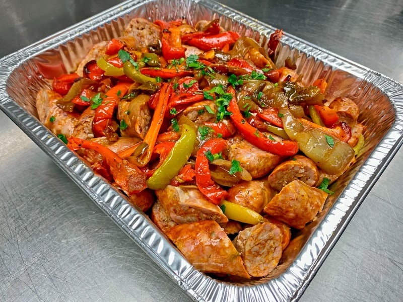 Catering pan of Italian sausage with peppers and onions