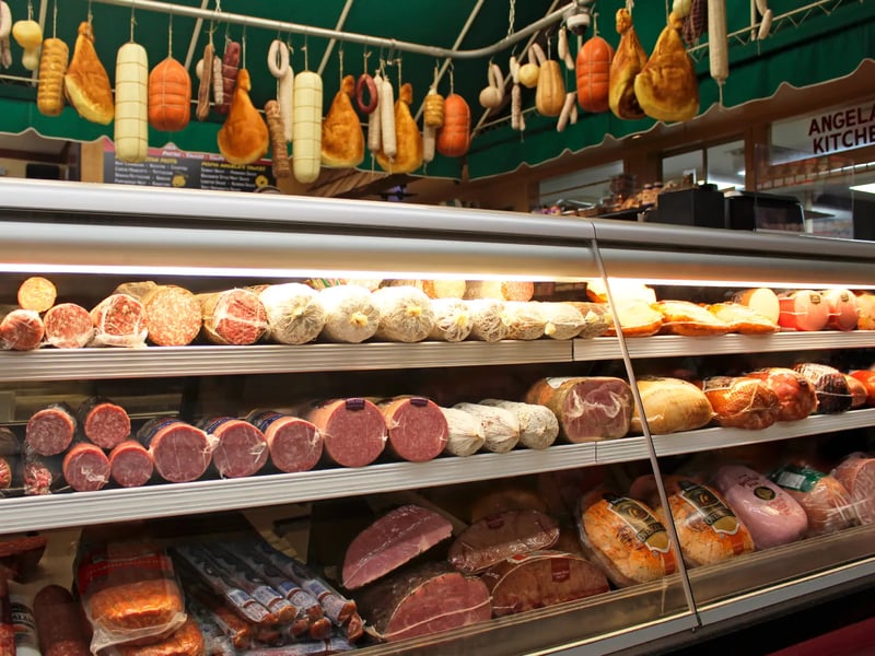 Sliced prosciutto and Italian deli meats at Sam's deli counter