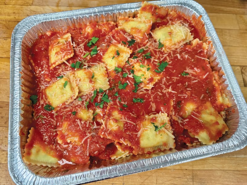 Catering tray of cheese ravioli in marinara with parmesan and parsley