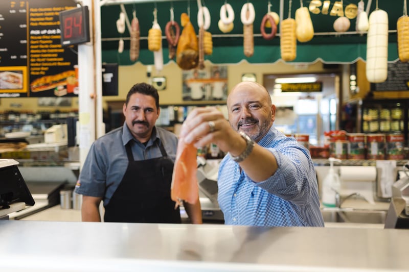 Nick Marziliano and a deli clerk serving customers at Sam's